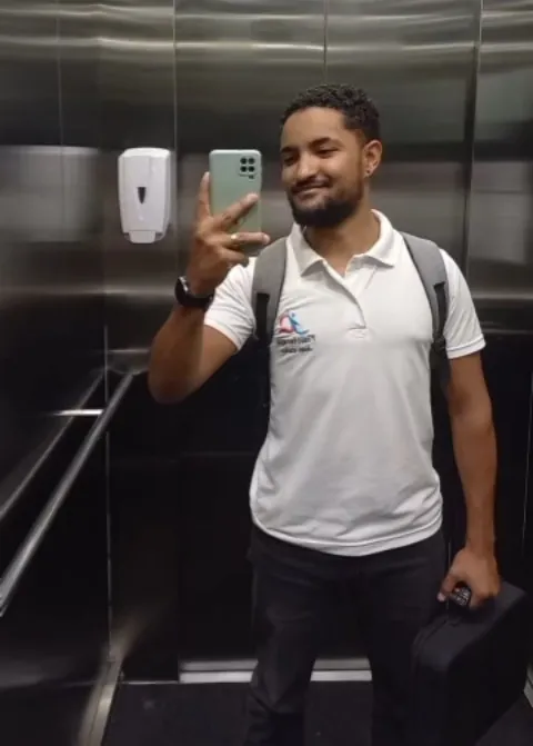 Jean Carlos no elevador a caminho de um atendimento domiciliar com a maca portátil